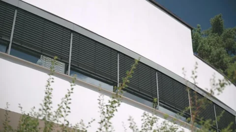 Modern White Building Facade with Horizontal Window Blinds Slowly Opening 스톡 동영상 326342587