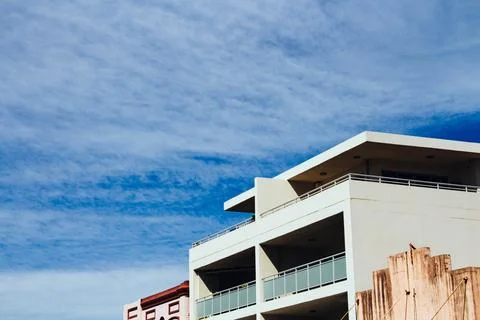 Modern White Building With Large Balconies Against A Clear Blue Sky In The Ci Stock Photos