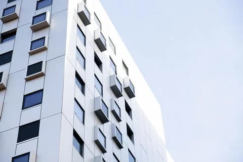 Modern white building with square windows. Multistory apartment building. Stock Photos
