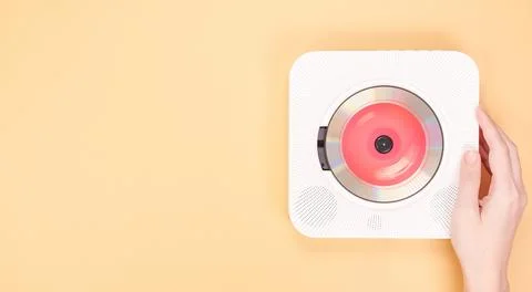 Modern white CD player with compact disc isolated on a warm yellow background Stock Photos