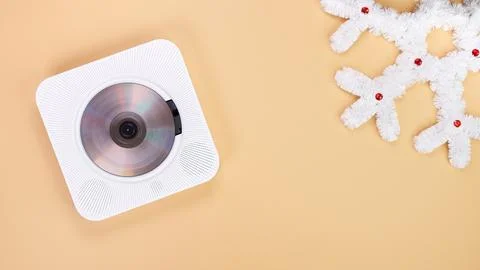 Modern White CD Player with Snowflake Decoration on Beige Background. Isolated Stock Photos