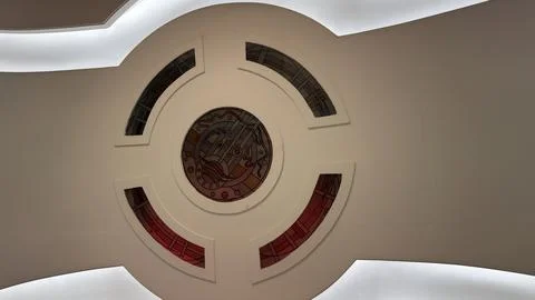 Modern white ceiling structure featuring an elegant circular stained glass pa Foto stock