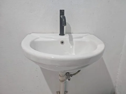 Modern White Ceramic Wall Mounted Bathroom Sink With Black Faucet Photos