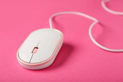 Modern white computer mouse on pink background Stock Photos