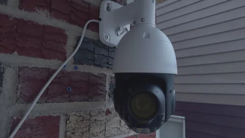 Modern White Dome CCTV Camera on House Exterior Evening Vidéo 330671740