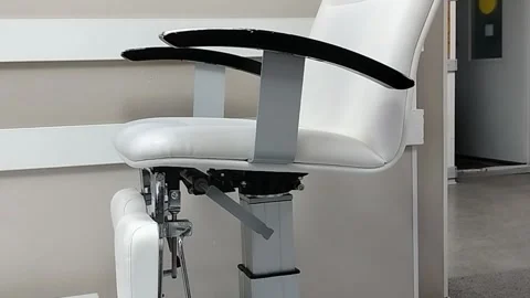 Modern white ergonomic chair with adjustable height and armrests positioned Stock Footage 331984092