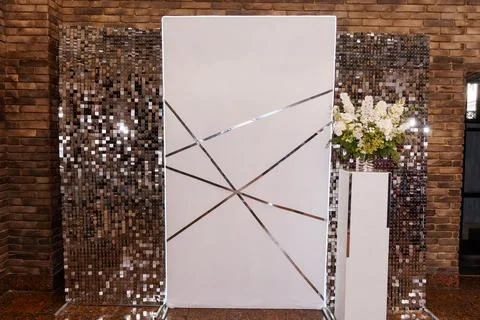 Modern white event backdrop with silver geometric lines and shimmering sequ.. Stock Photos