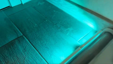 Modern white floor vacuum cleaning tool operating on a wooden surface Stock Footage 345023850
