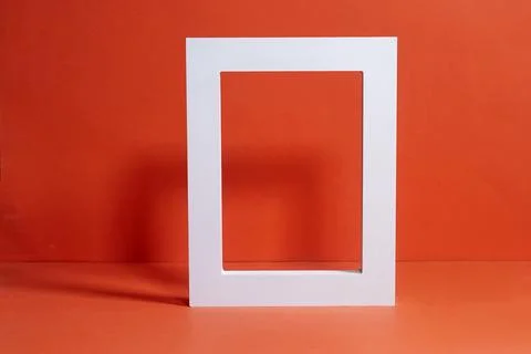 Modern White Geometric Frame on a Vibrant Orange Background Stock Photos