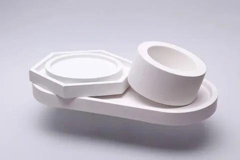 Modern white geometric objects on a simple white surface Stock Photos