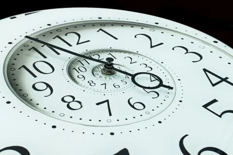 Modern white infinity time spiral clock. Infinite time concept. Stock Photos