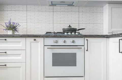 Modern white kitchen interior, front view Stock Photos