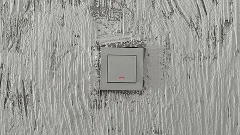 Modern White Light Switch on Gray Decorative Textured Wall 写真素材