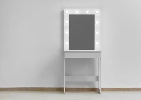 Modern white makeup dressing table with mirror and backlight on a white wal.. Stock Photos