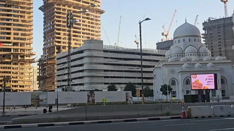 Modern white mosque stands in a developing city landscape with rising Video stock 337906380