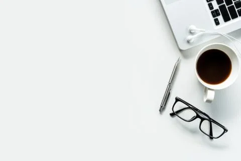 Modern white office desk table with laptop, cup of coffee and supplies. Top v Stock Photos