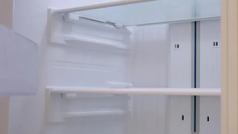 Modern white open refrigerator close-up with empty shelves. Stock Footage 300822352