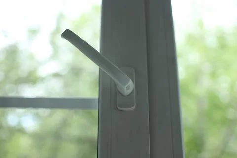 Modern white pvc window handle in the open position allowing fresh air into the Stock Photos