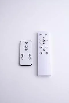 Modern white remote control isolated on white background flat lay and top vie Stock Photos
