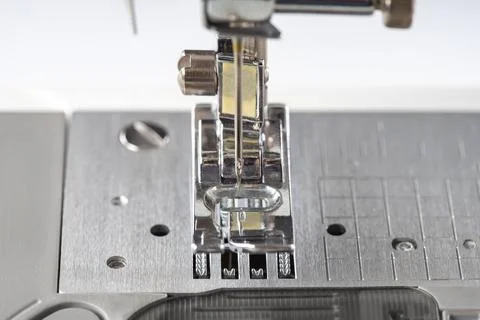 Modern white sewing machine presser foot closeup, macro Stock Photos