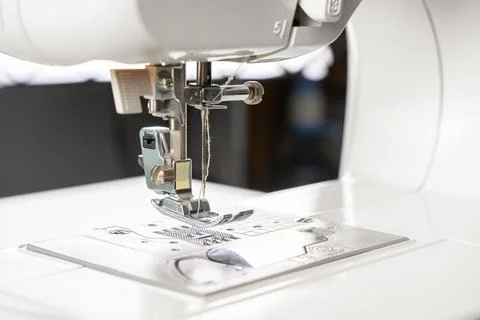 Modern white sewing machine presser foot closeup, macro Foto stock