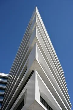 Modern White Skyscraper Low Angle View Against Blue Sky Stock Photos