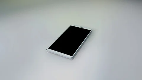 Modern white touchscreen android cellphone tablet smartphone isolated on light Video stock 74804756