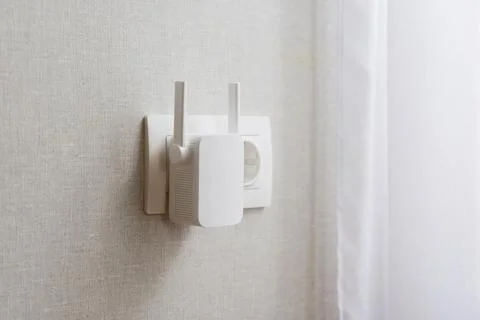 Modern WiFi Range Extender Plugged into Wall Outlet Stock Photos