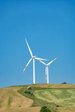 Modern wind farm with big wind turbines towers, source for renewable green en Stock Photos
