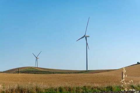 Modern wind farm with big wind turbines towers, source for renewable green en Stock Photos