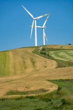 Modern wind farm with big wind turbines towers, source for renewable green en Stock Photos