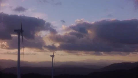Modern wind generators standing on a mountain range against a dramatic evening s Stock Footage 341973341