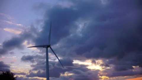 Modern wind generators standing on a mountain range against a dramatic evening s Stock Footage 341973435