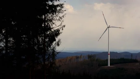 A modern wind turbine in an evening forest Stock Footage 152425320
