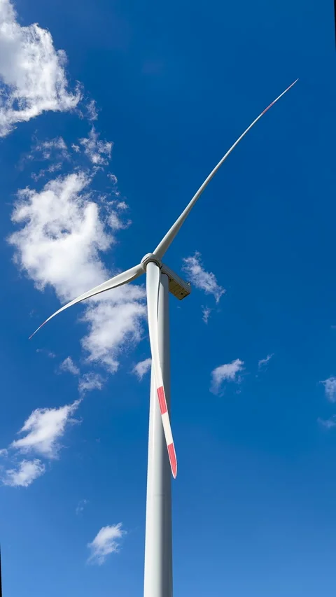 Modern Wind Turbine Generating Clean Energy Against Blue Sky Stock Footage 307135727