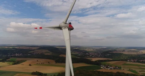 The modern wind turbine is rotating at the background of beautiful golden fields Stock Footage 87476626