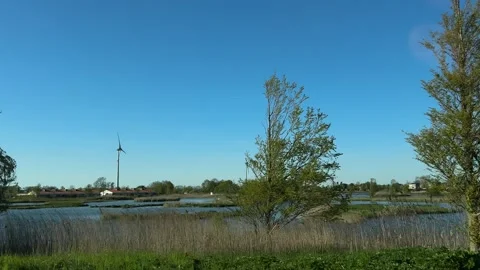 Modern wind turbines over water in the Netherlands, renewable energy landscape Stock-Footage 342750833
