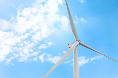 Modern windmill against sky with clouds, space for text. Energy efficiency Stock Photos