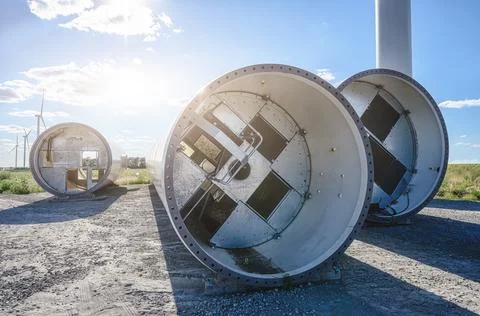 Modern windmill in front of disassembled old. Windmill for electric power pro Stock Photos