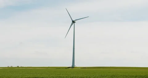 Modern windmill in a green field on a cloudy sky Stock Footage 189336552