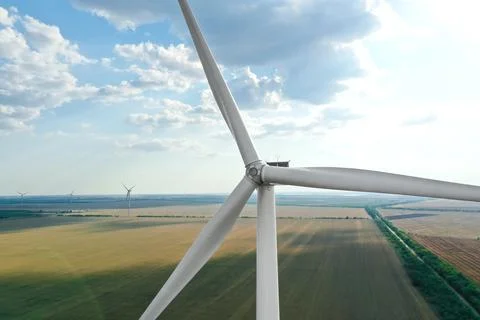 Modern windmill in wide field. Energy efficiency Stock Photos