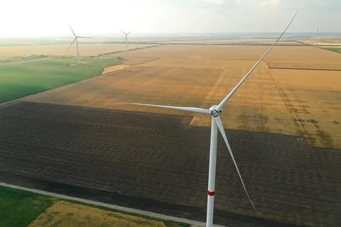 Modern windmill in wide field. Energy efficiency Stock Photos