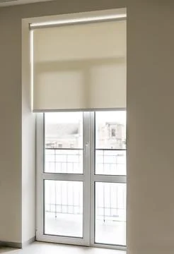 Modern window design with roller shade and view of balcony Stock Photos