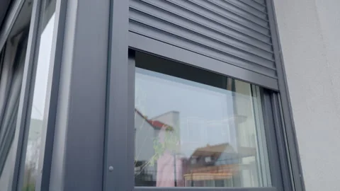 Modern window with roller shutter closing on house exterior 库存影片 331740062
