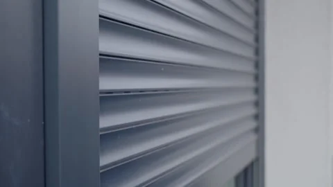 Modern window with roller shutter closing on house exterior 库存影片 332203921