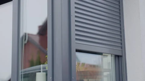 Modern window with roller shutter opening on house exterior Stock Footage 331740159