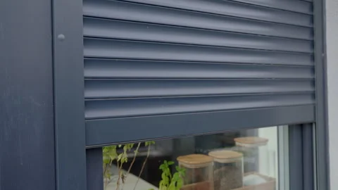 Modern window with roller shutter opening on house exterior Stock Footage 332637311
