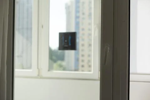 Modern window washer robot performs work on a dirty window. Cleaning the house Stock Photos