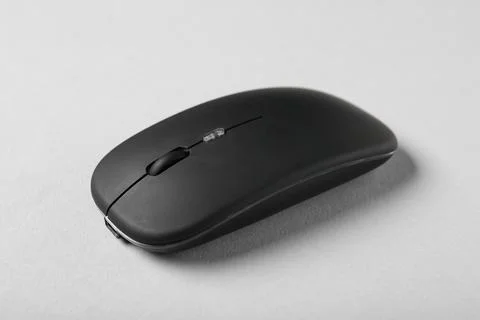 Modern wireless black computer mouse on grey background Stock Photos