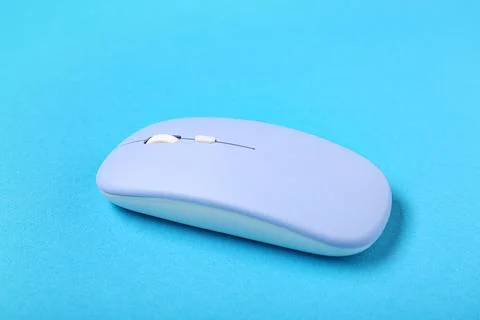 Modern wireless blue computer mouse on color background Stock Photos